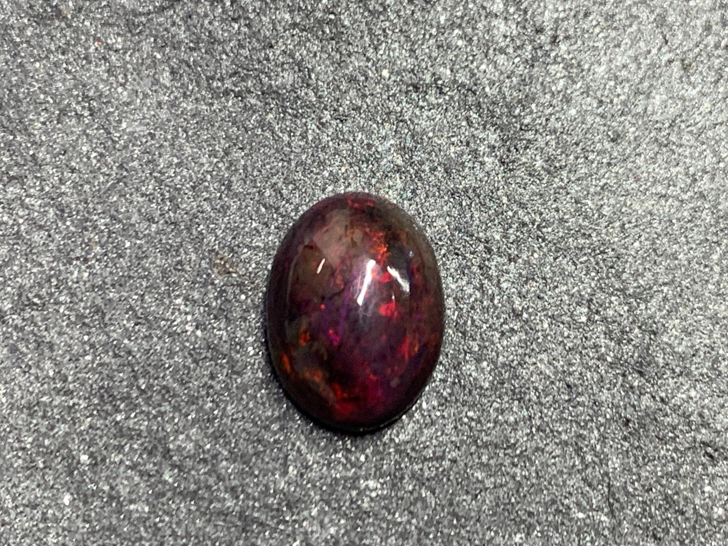 Black Ethiopian Opal oval 8x11x4.5mm cabochon.