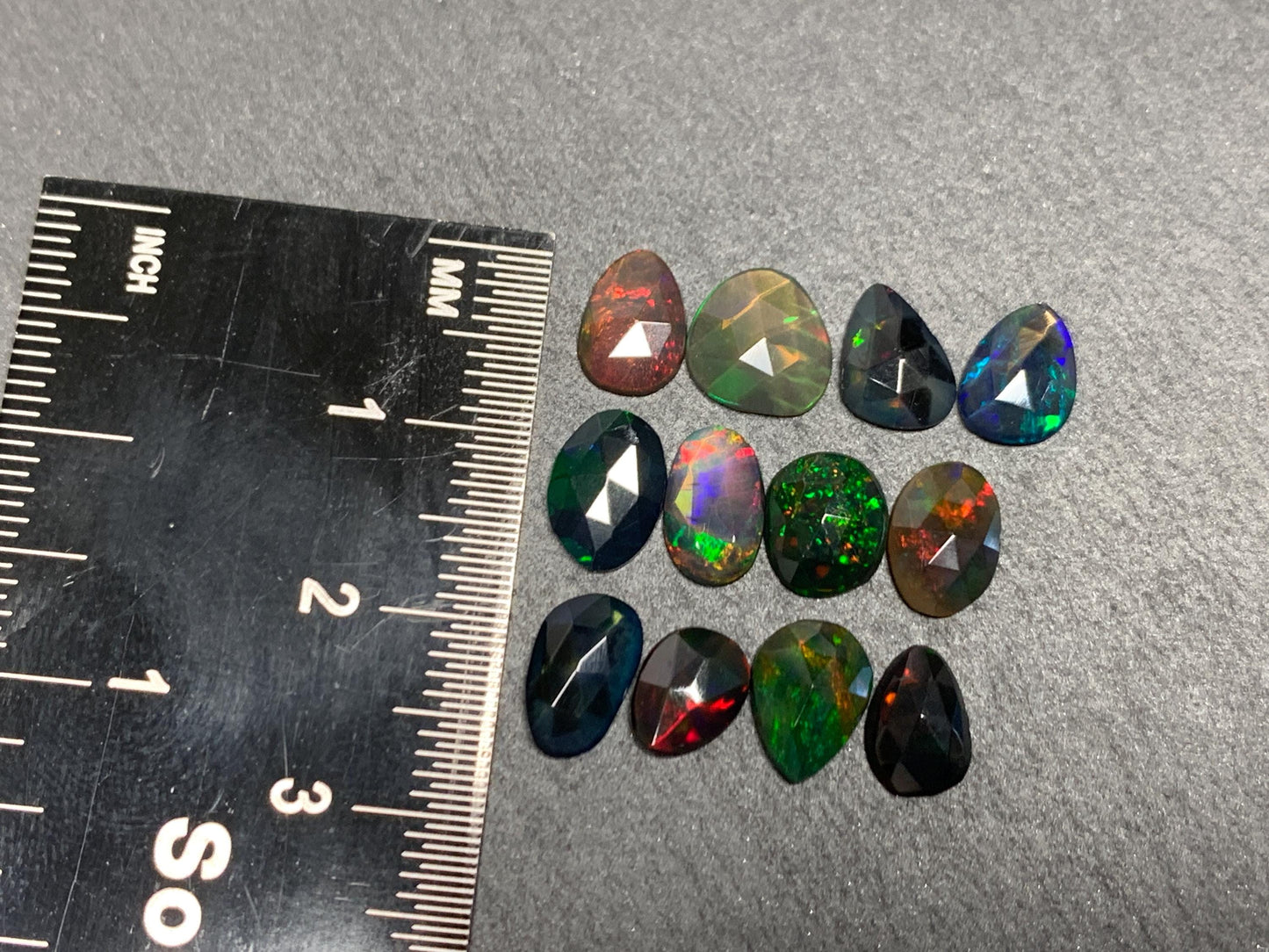 Faceted Black Opal free form 7-9mm long cabochon