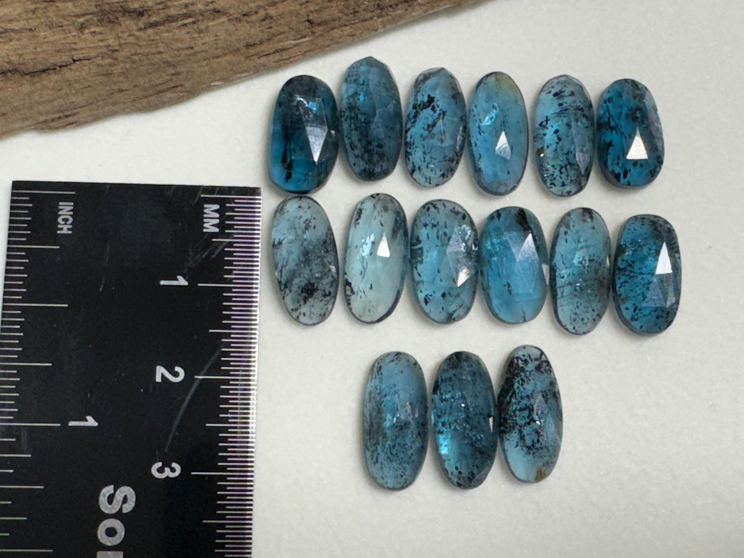 Faceted Moss Kyanite oval 13-15mm long cabochon