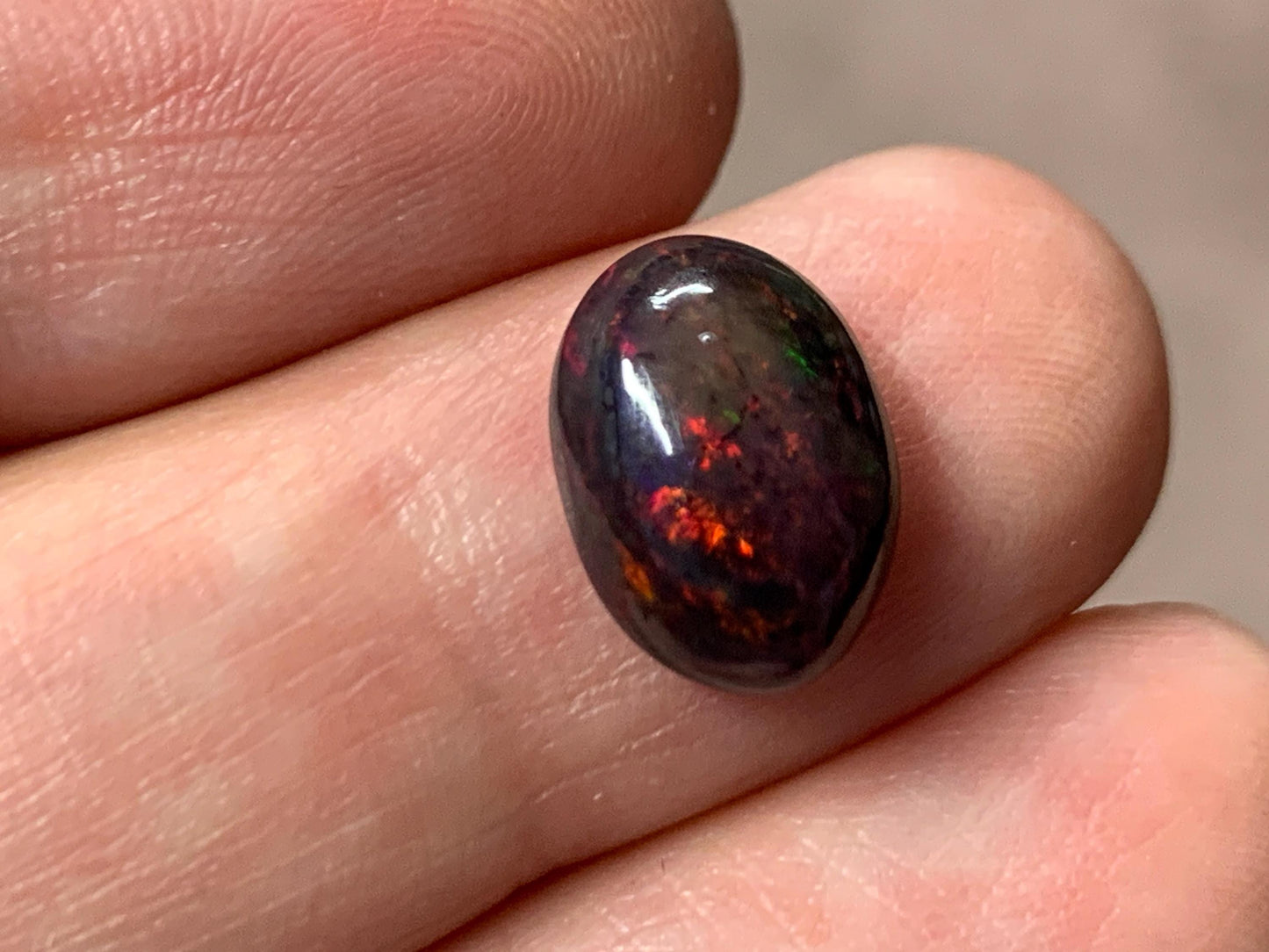 Black Ethiopian Opal oval 8x11x4.5mm cabochon.