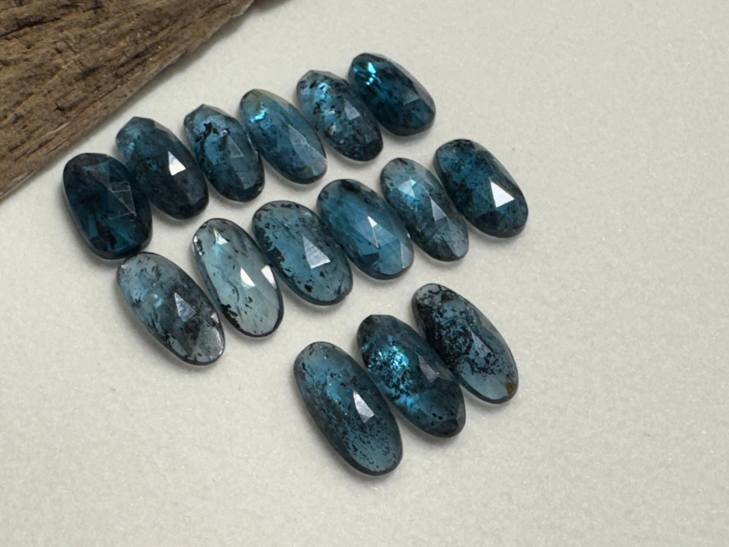 Faceted Moss Kyanite oval 13-15mm long cabochon