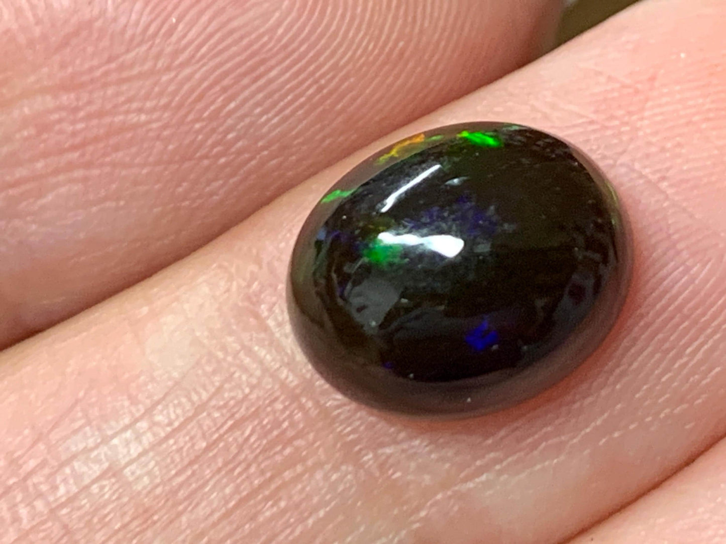 Natural Ethiopian Black Opal 9x11x5mm cabochon