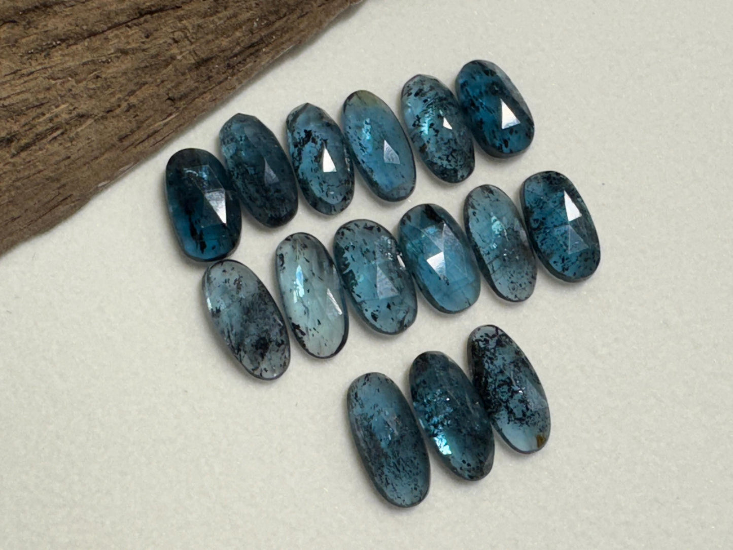 Faceted Moss Kyanite oval 13-15mm long cabochon