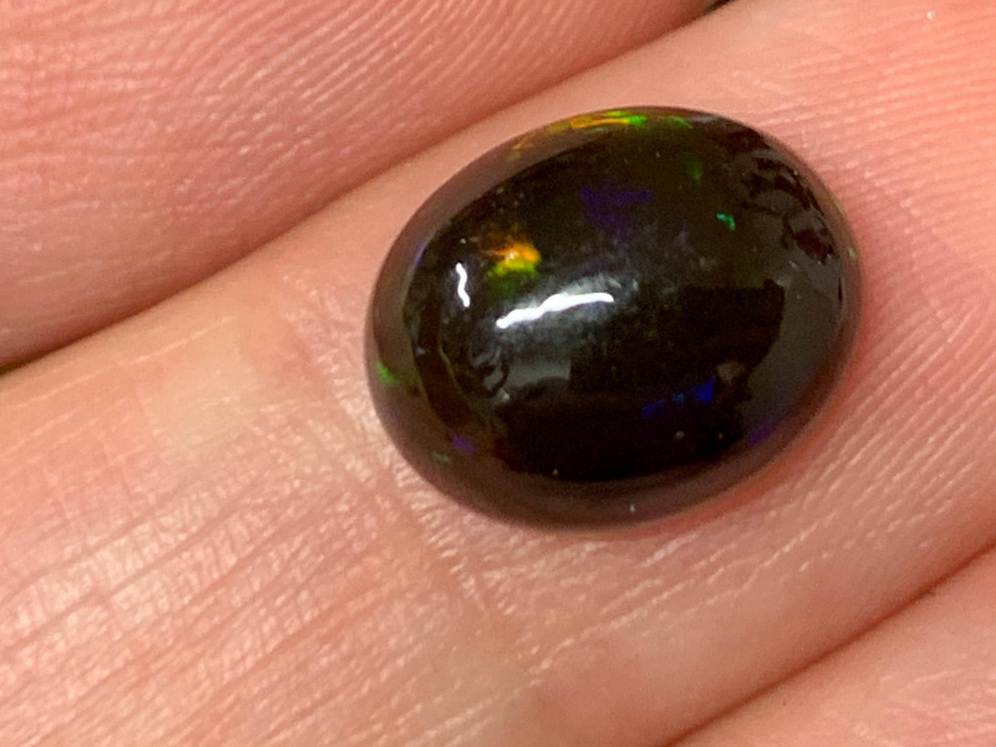 Natural Ethiopian Black Opal 9x11x5mm cabochon