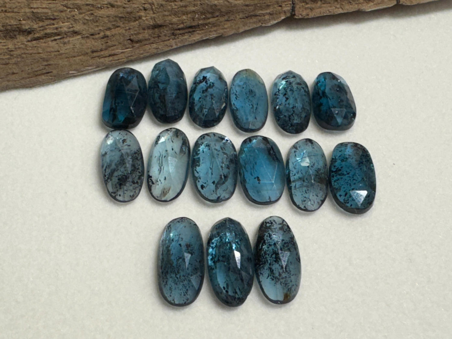 Faceted Moss Kyanite oval 13-15mm long cabochon