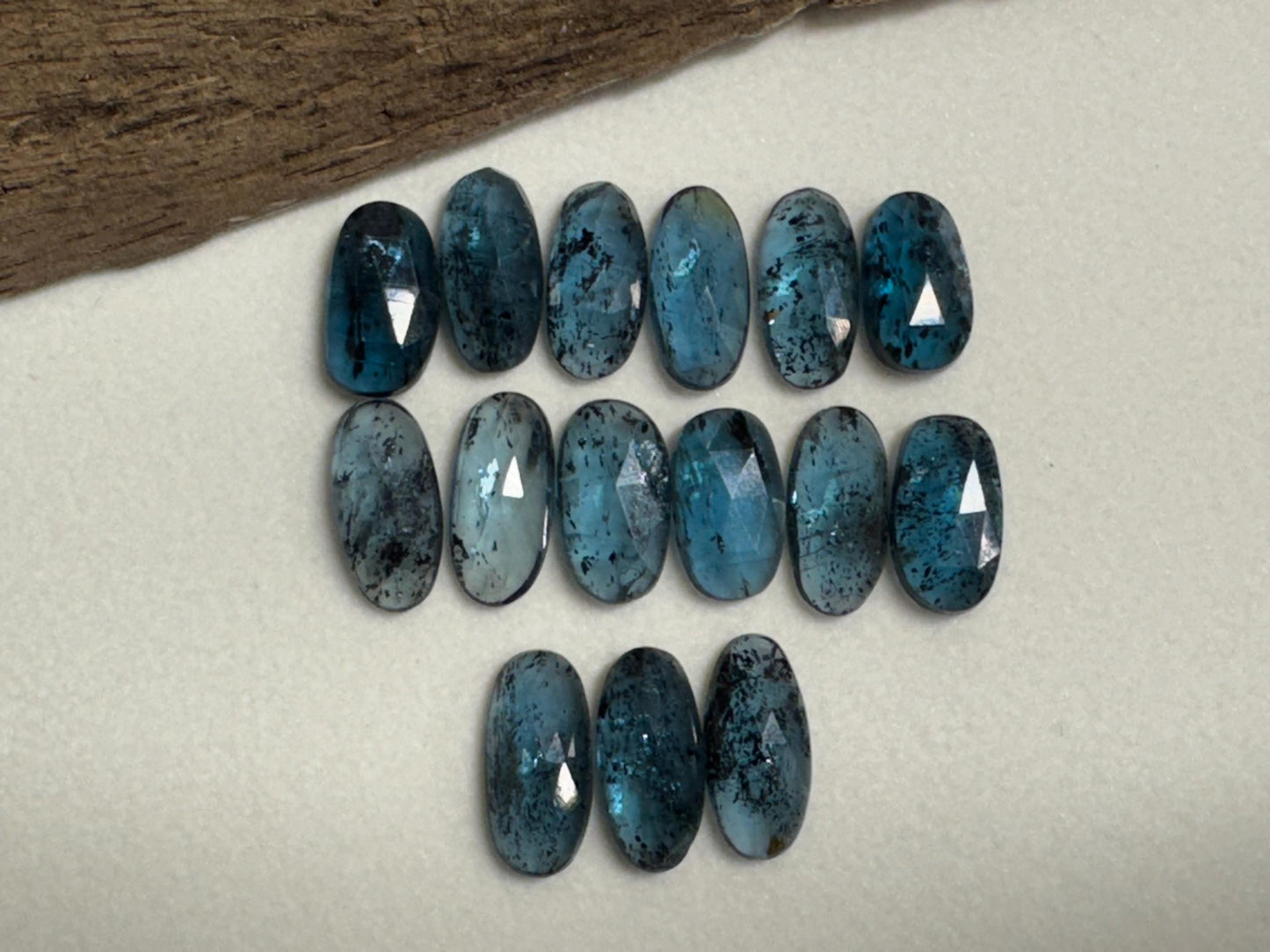 Faceted Moss Kyanite oval 13-15mm long cabochon