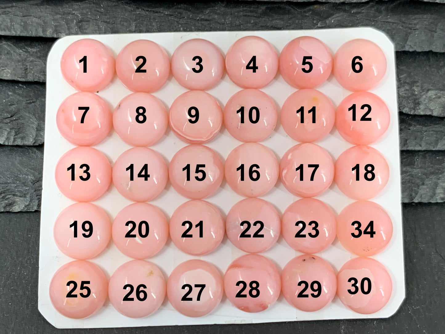 a large number of pink balls on a table