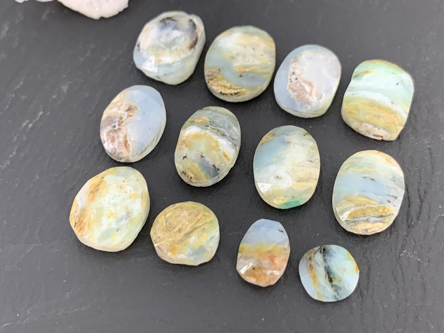 Faceted Peruvian Opal 8-14mm long cabochon.