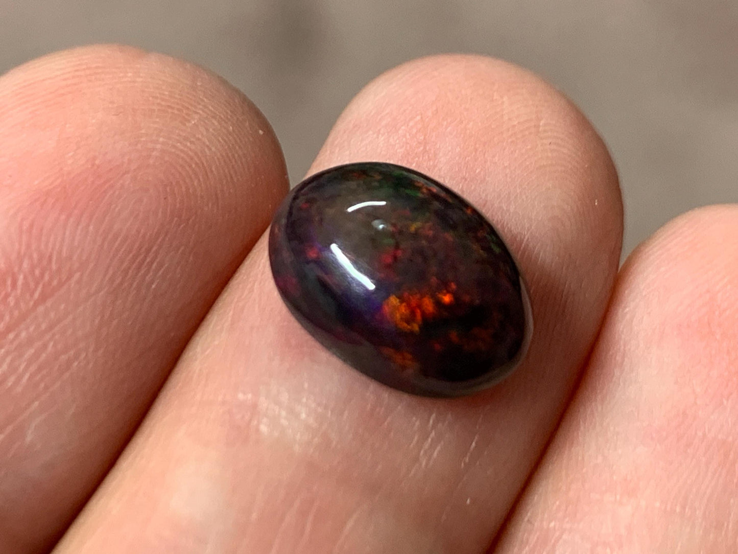 Black Ethiopian Opal oval 8x11x4.5mm cabochon.
