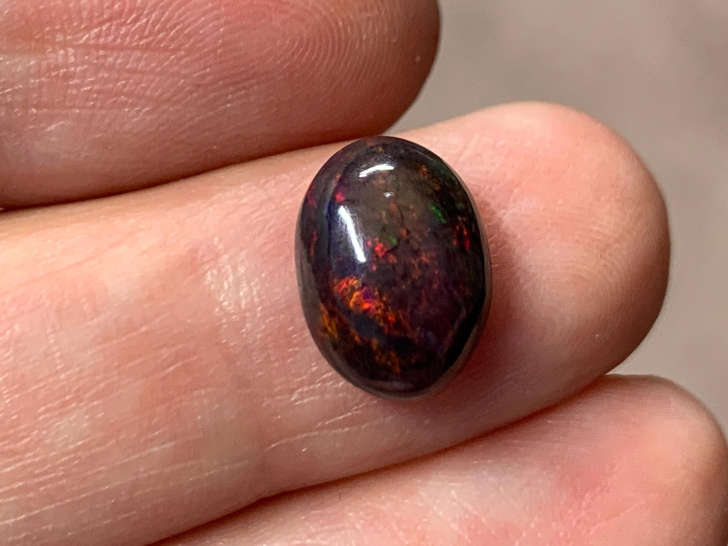 Black Ethiopian Opal oval 8x11x4.5mm cabochon.