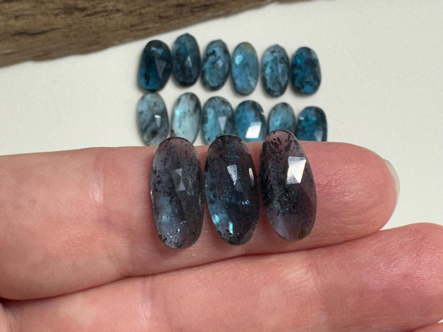 Faceted Moss Kyanite oval 13-15mm long cabochon