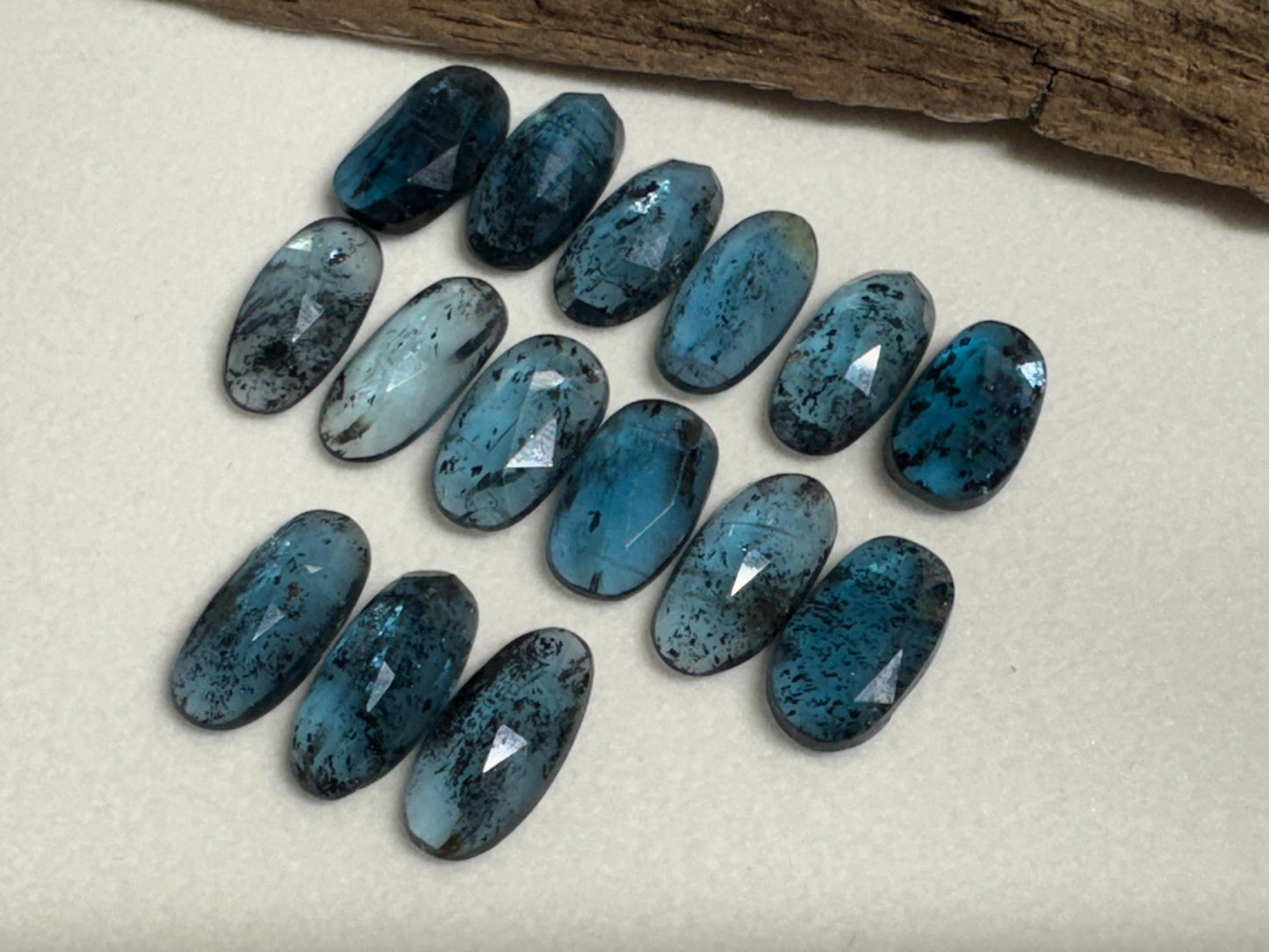 Faceted Moss Kyanite oval 13-15mm long cabochon