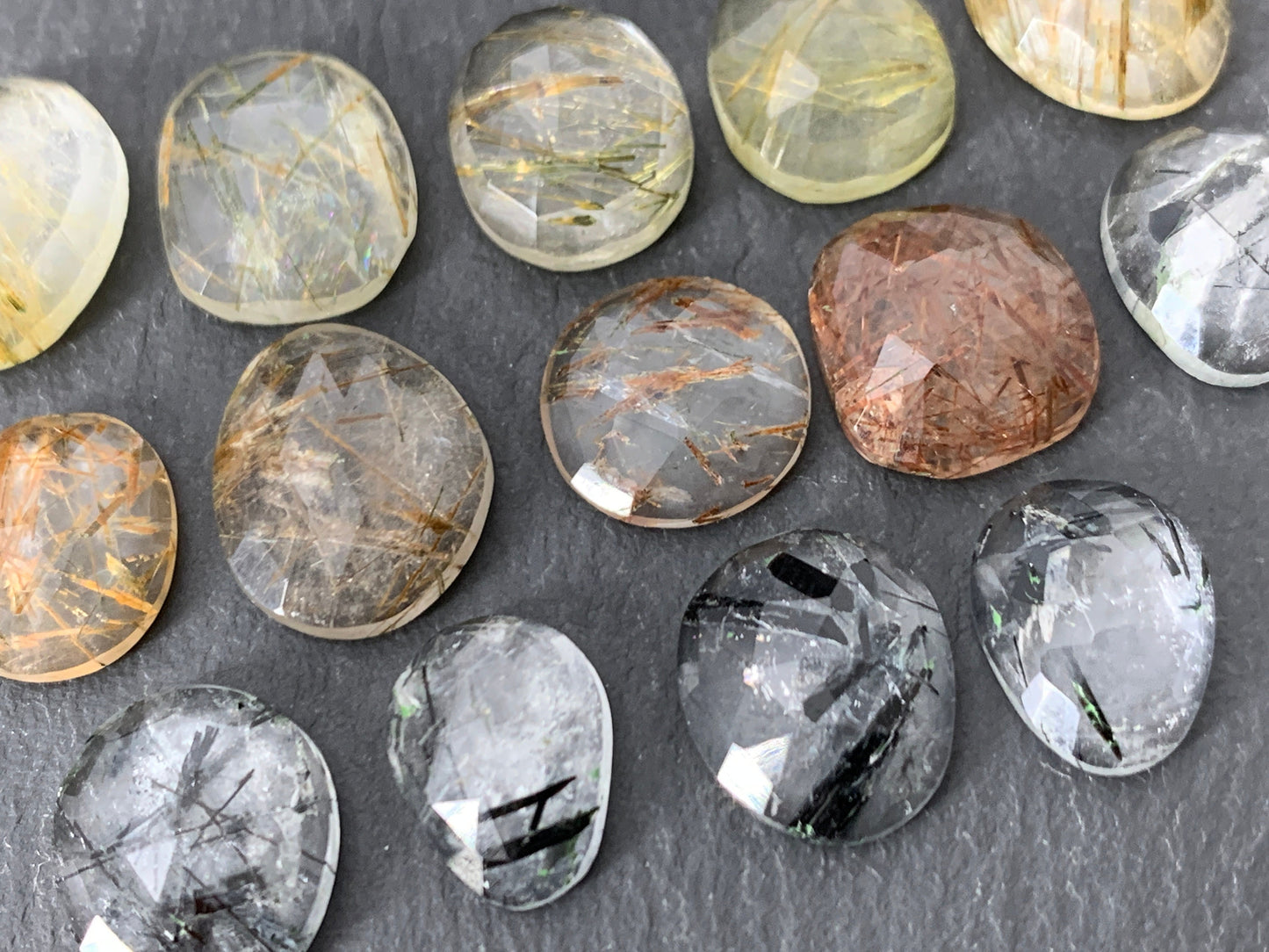 Faceted rutilated quartz oval 10-12mm long cabochon