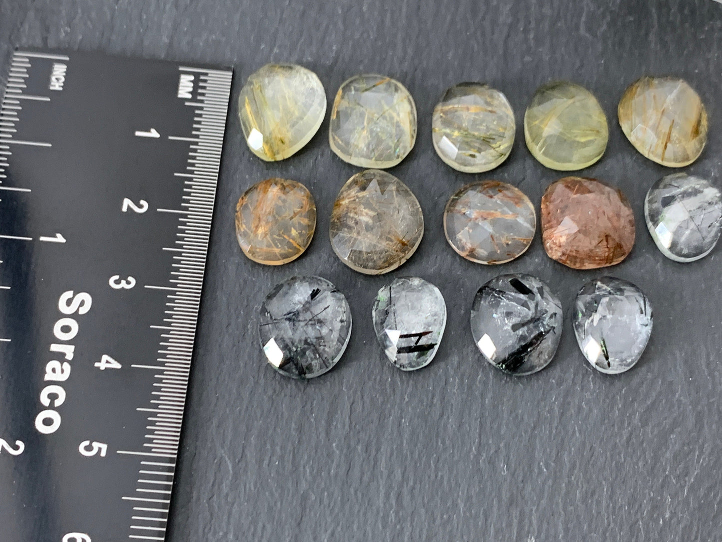 Faceted rutilated quartz oval 10-12mm long cabochon