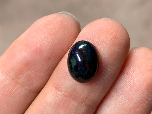Black Ethiopian Opal oval 8x11x5mm cabochon