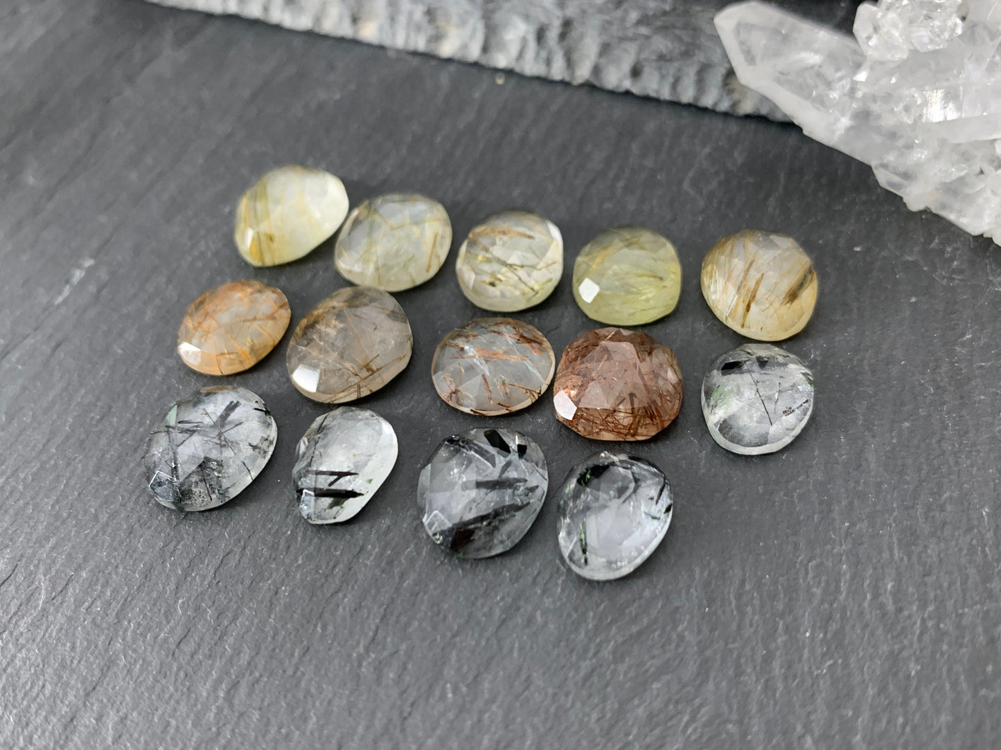 Faceted rutilated quartz oval 10-12mm long cabochon