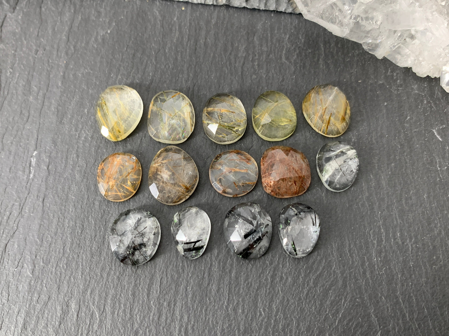 Faceted rutilated quartz oval 10-12mm long cabochon