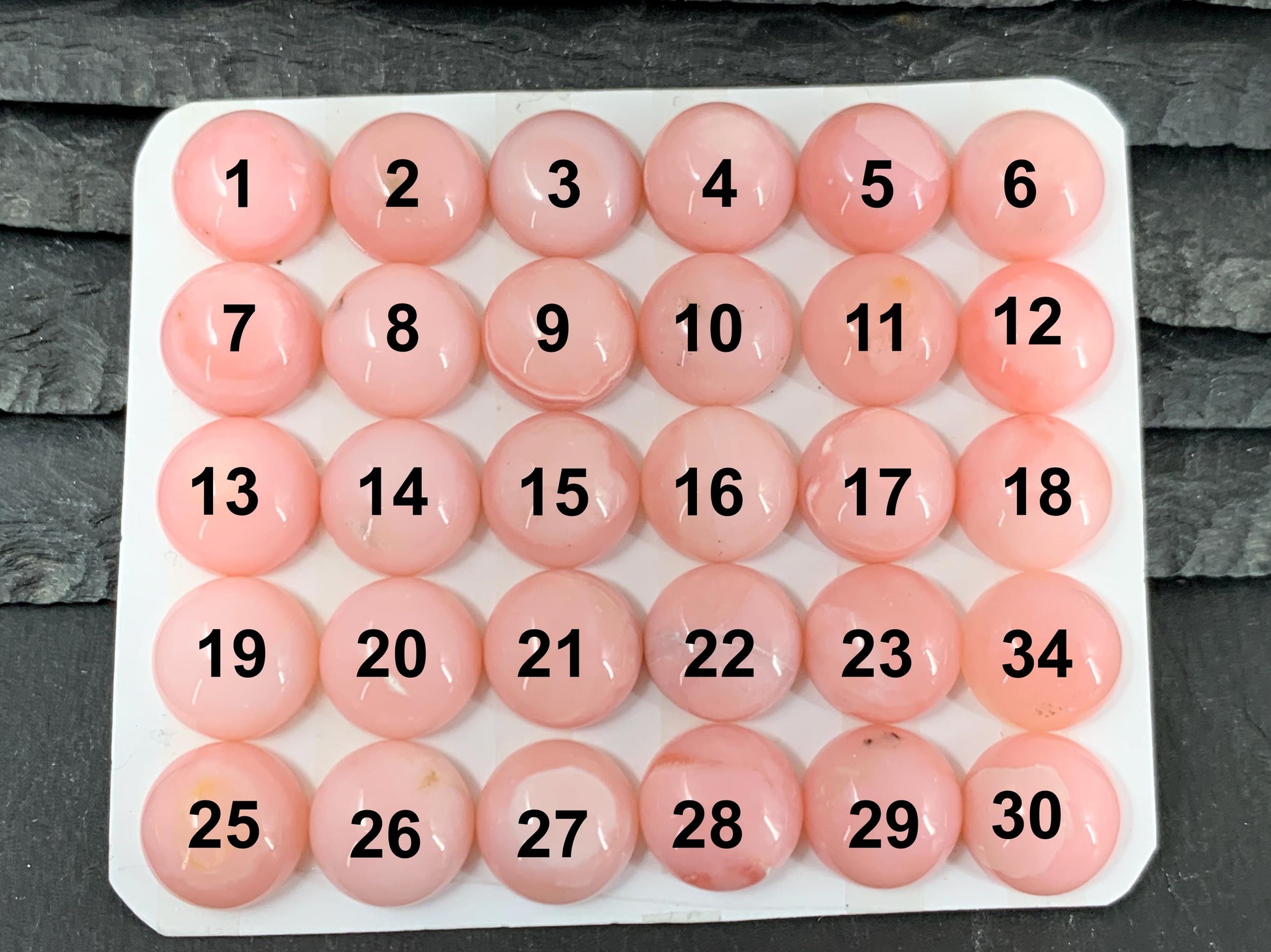 a large number of pink balls on a table