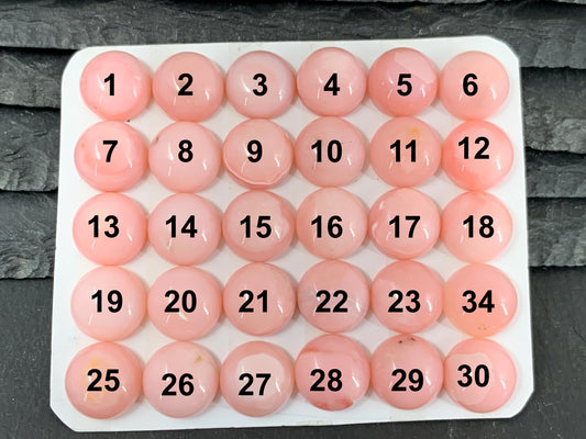 a large number of pink balls on a table