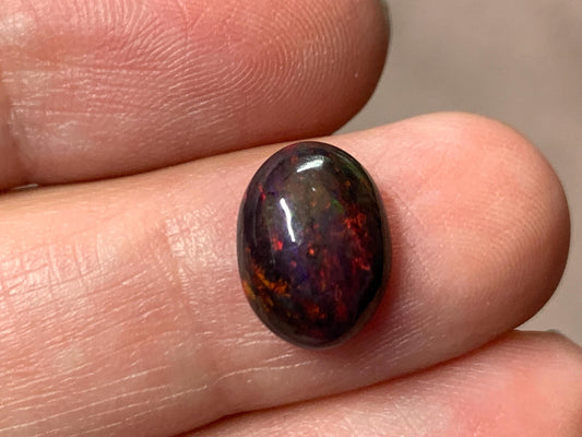 Black Ethiopian Opal oval 8x11x4.5mm cabochon.