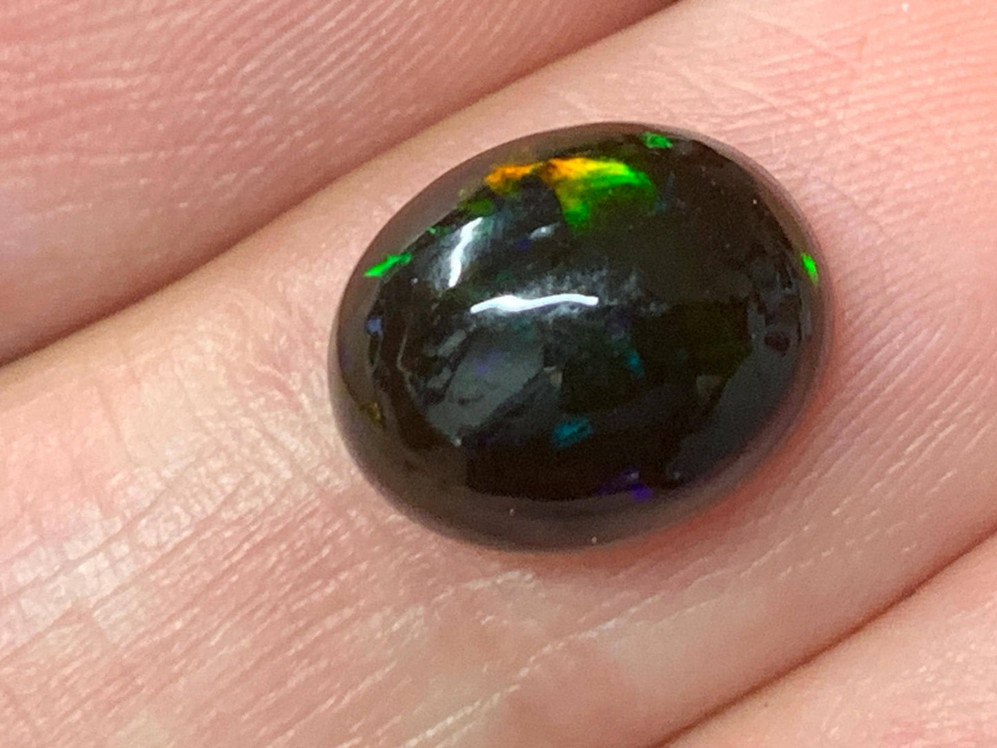 Natural Ethiopian Black Opal 9x11x5mm cabochon