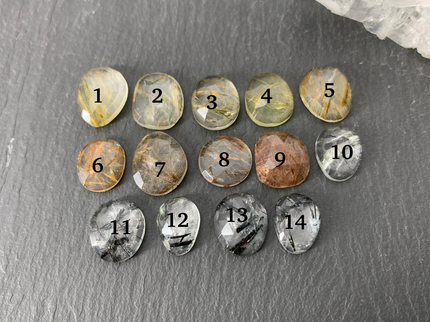 Faceted rutilated quartz oval 10-12mm long cabochon