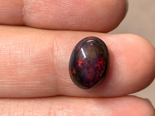 Black Ethiopian Opal oval 8x11x4.5mm cabochon.