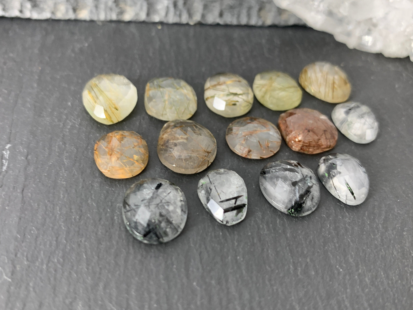 Faceted rutilated quartz oval 10-12mm long cabochon