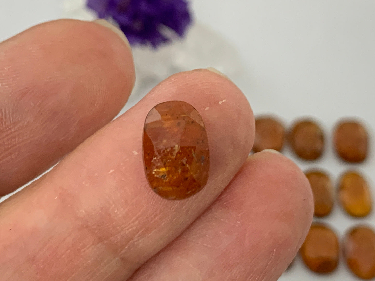 Faceted Orange Kyanite oval 10-11mm cabochon